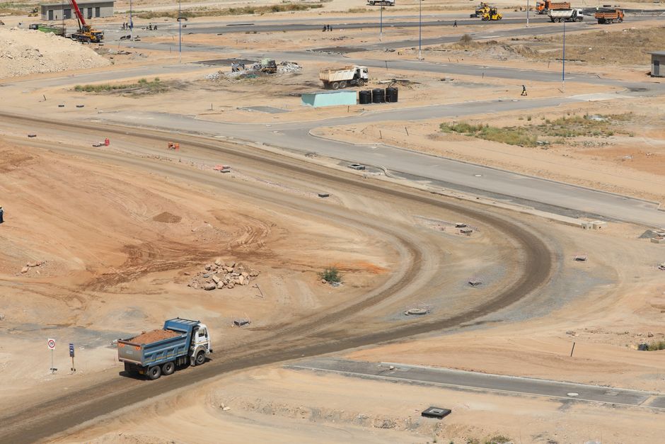 Drone shot of a developing construction site in Konza, Machakos County with dump trucks and dirt roads.
