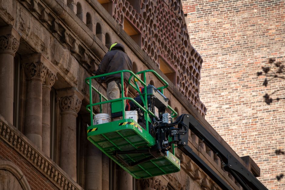 High-rise building restoration project using modern lift equipment.