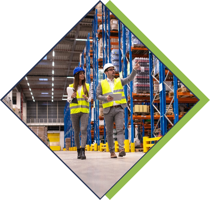 Two project managers walking through industrial warehouse