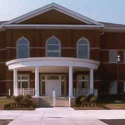 Building with large white entrance and front porch