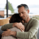 man comforting a grieving woman