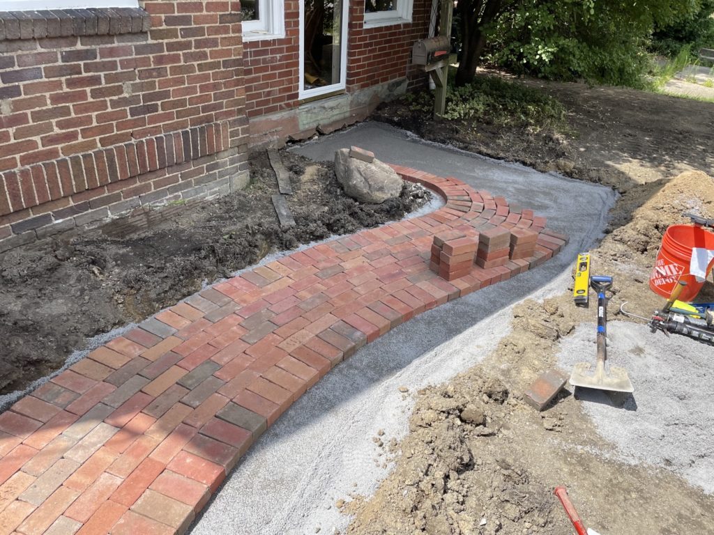 installation of red brick walkway at a residential property