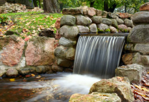 gorgeous waterfall with stone retention wall