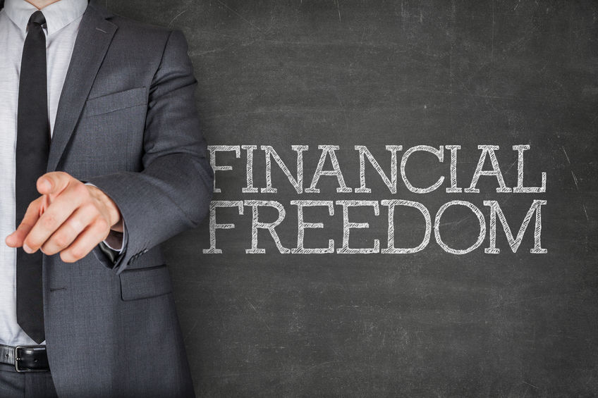 43450907 - financial freedom on blackboard with businessman finger pointing
