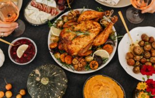picture of a thanksgiving table setting with the turkey in the middle and pumpkins