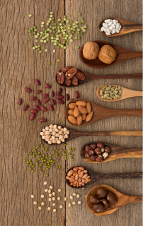 picture of wooden spoons holding dried beans and nuts which are high in fiber