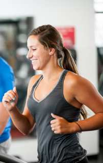 woman enjoying herself running on a treadmill