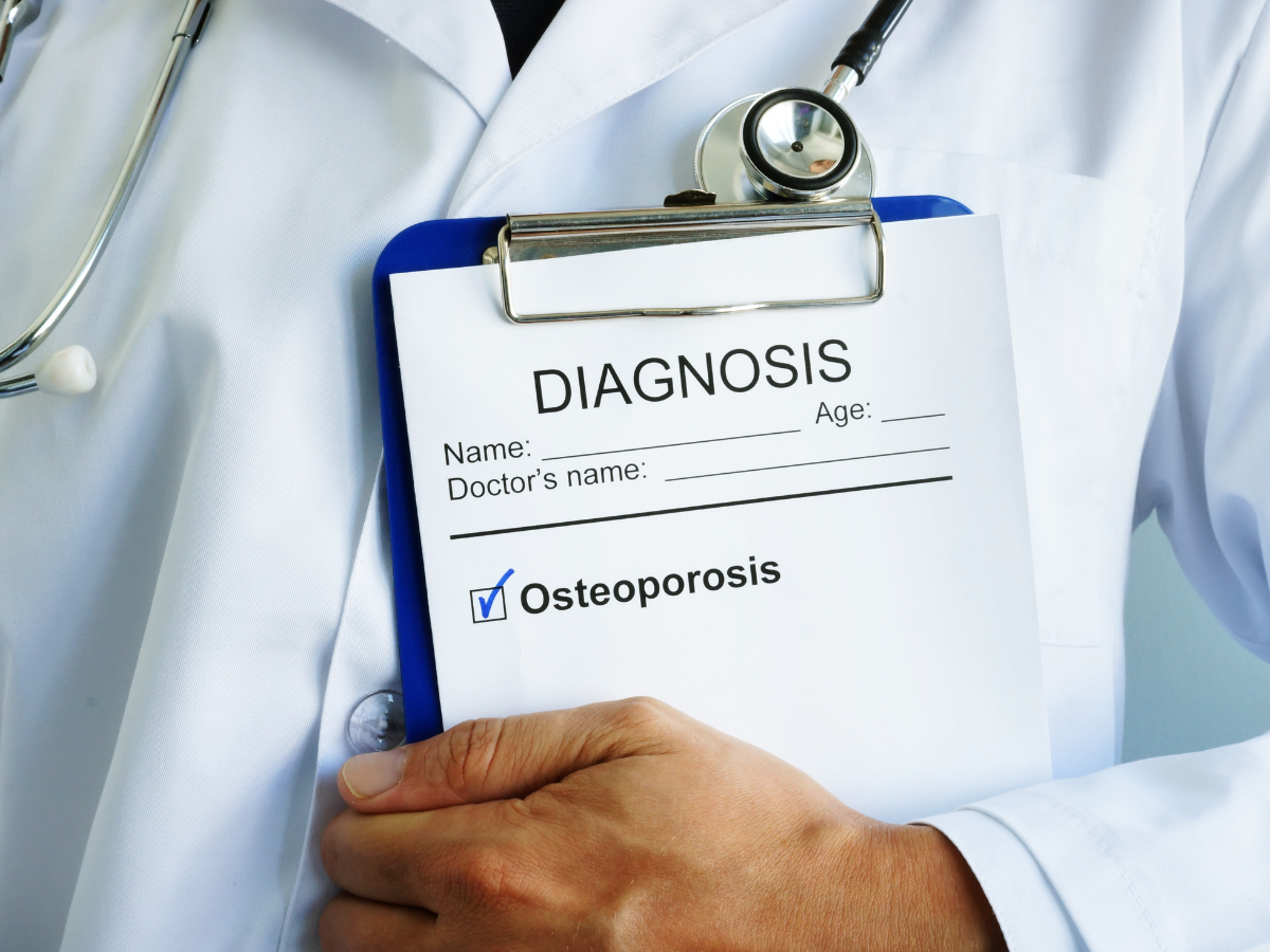 picture of doctor holding clipboard with osteoporosis written on it