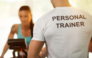 personal trainer training a client in a gym
