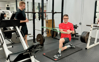 mike black doing an rotational ab exercise under the guidance of his personal trainer