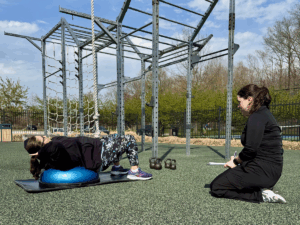 amy performing ab exercises on a bosu ball under the guidance of personal trainer ella