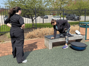 amy performing kettlebell rows on a bench