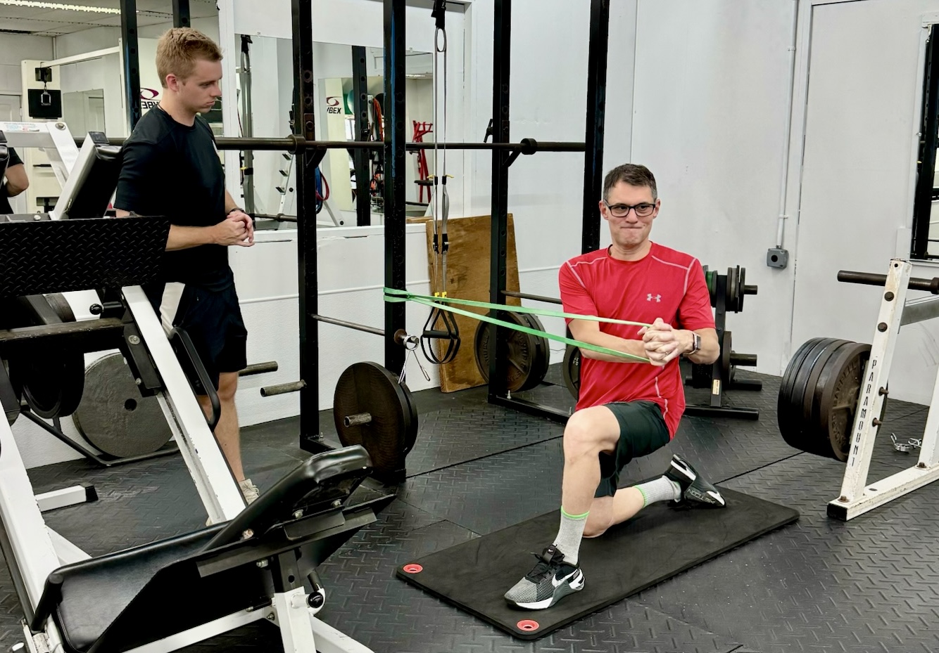 mike black doing an rotational ab exercise under the guidance of his personal trainer