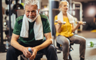 Older adult resting with water after a strength training workout