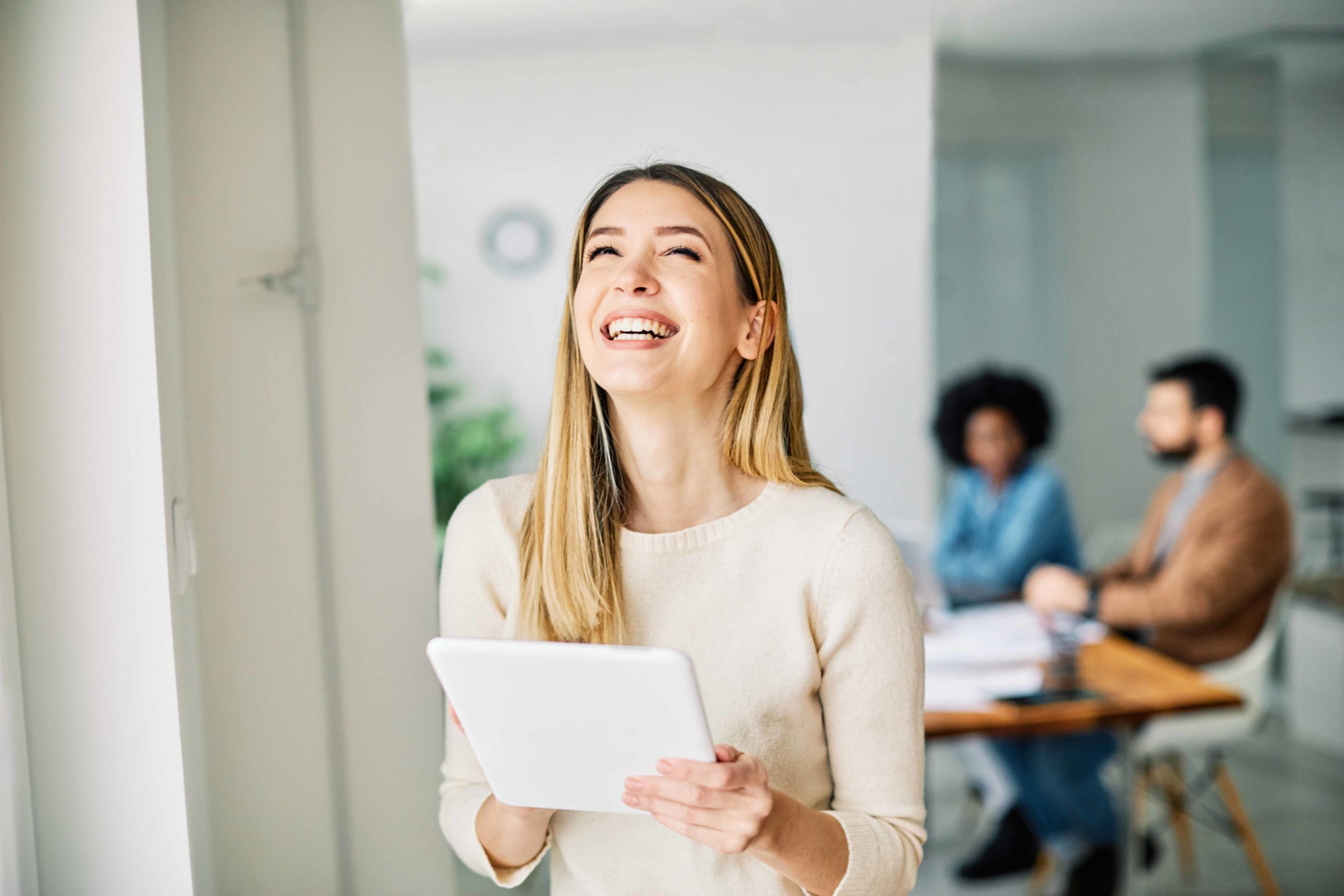 portrait of a smiling young businesswoman holding a tablet in the office