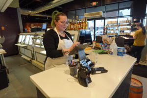 Female cashier at Astoria Market & Cafe