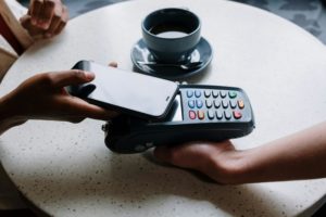Person paying with card at terminal